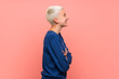 © luismolinero - Teenager girl with white short hair over pink wall in lateral position