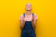 Teenager girl with overalls on yellow background applauding after presentation in a conference