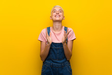 Teenager Girl With Overalls On Yellow Background Applauding After Presentation In A Conference