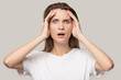 © fizkes - Stunned millennial woman look at camera shocked by bad news