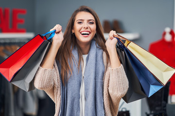 Sticker - Adult women shopping for clothes in boutique in autumn