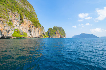 Phi Phi, Maya beach with blue turquoise seawater, Phuket island in summer season during travel holidays vacation trip. Andaman ocean, Thailand. Tourist attraction with blue cloud sky.