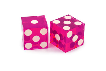 Two pink professional game dice closeup isolated on a white background / one and five with a light shadow.