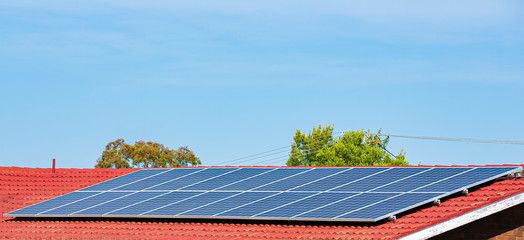 Wall Mural - view of rooftop solar power panels for clean, free and renewable energy supply in australian homes