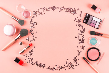 Wall Mural - Make up products on pink coral with sparkling confetti frame. Beauty items colorful fashion flat lay background