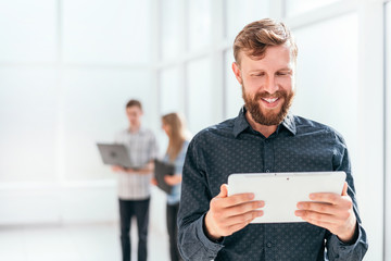 Wall Mural - happy businessman looking at the screen of his digital tablet