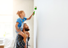 Repair In Apartment. Happy Family Father And Child Daughter Paints Wall