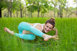 © Kate - A young sports girl practices yoga in a quit green summer forest, yoga assans posture. Meditation and unity with nature