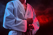 © fotokitas - Karate martial arts fighter on dark background