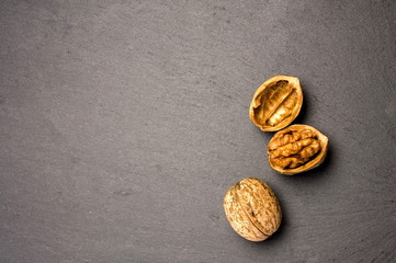 Walnut on a slate plate on a dark background close-up