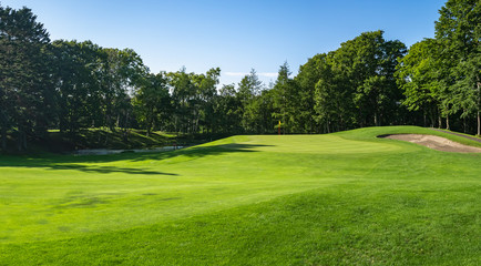 Wall Mural - Golf Course with beautiful green field. Golf course with a rich green turf beautiful scenery.