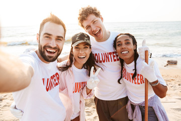 Group of happy young friends volunteers making a selfie