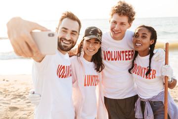 Sticker - Group of happy young friends volunteers making a selfie