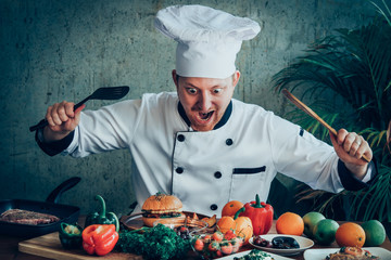 Funny chef looking at food on the wood table exciteing mood