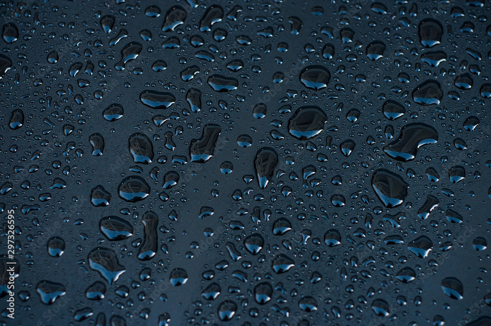 Closeup of rain drops of black metaliic surface - obrazy, fototapety, plakaty 