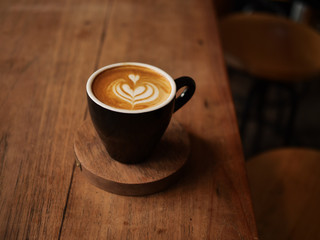 cup of coffee on wooden table