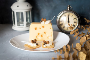 Christmas mouse food made of cream cheese on a white plate. Food art concept. New Year food.