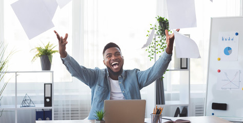 Poster - Cheerful african american employee celebrating success throwing papers in office