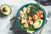 Buddha Bowl With Quinoa, Tofu, Avocado, Sweet Potato, Brussels Sprouts And Tahini Dressing, Top View. Healthy Vegan Food Concept.