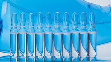 Glass Medical Ampoule Vial For Injection. Medicine Is Liquid Sodium Chloride With Of Aqueous Solution In Ampulla. Close Up. Bottles Ampule Multicolor.