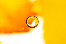 Abstract Colorful Background. Foam Of Soap With Bubbles Macro Shot. Closeup Bubbles In Water. Oil Drops On A Water Surface Abstract Background. Golden Yellow Bubble.Yellow Water Bubbles Wallpaper