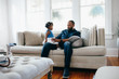 © Gerald Carter/Creative Flame - Father with daughter sitting on couch