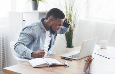 Poster - Angry businessman talking on phone and looking at laptop screen