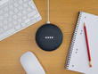 Smart home device speaker at full volume on wooden table desk