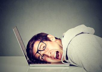 frustrated man feeling stressed with his laptop computer