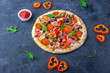 © Elena - A fresh prepared pizza with salami, mushrooms, ham and cheese on a dark background. Italian traditional lunch or dinner. Fast food and street food concept. Flat ly, top view, copy space fot text