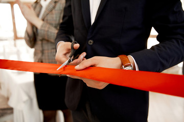 Front view of the cutting the red ribbon on the grand opening of the building