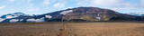 Fototapeta Natura - Panoramic Icelandic lava desert landscape with top of Eyjafjallajokull glacier and volcano, partialy covered in clouds. Iceland, Fimmvorduhals hiking trail. Summer sunny day.