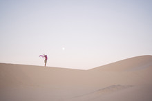 View Of Man Standing On Sand Dune