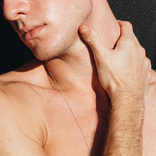 Close Up View Of Young Man Holding His Neck
