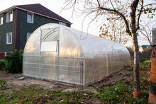 Polycarbonate Greenhouse In The Garden Near The Country House