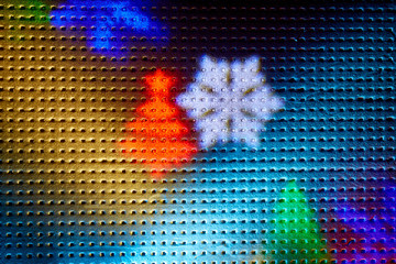 Two rays of light on a black background. Colored snowflakes and christmas trees