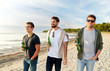 © Syda Productions - friendship and leisure concept - group of happy young men or male friends toasting non alcoholic beer walking along summer beach