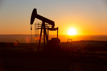 View of Oil Well Pumpjack (Horsehead) at Sunset Oil Industry