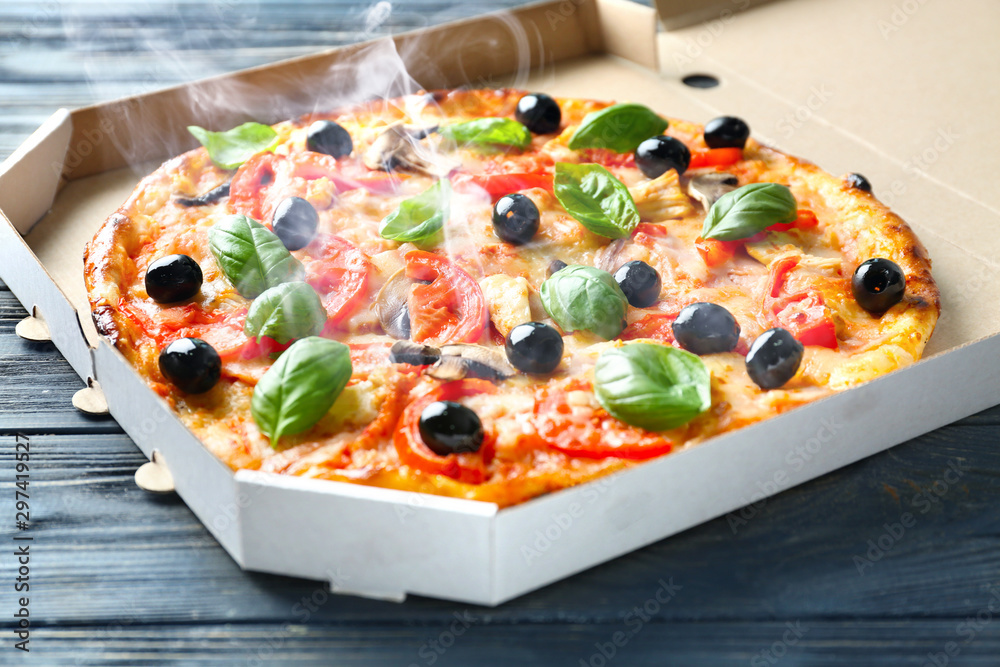 Box with tasty Italian pizza on wooden table - obrazy, fototapety, plakaty 