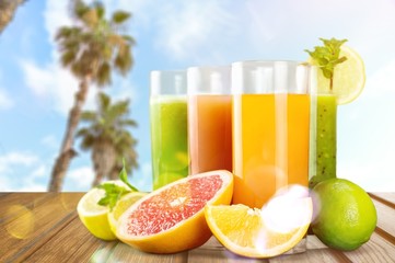 Wall Mural - Tasty fruits and juice on wooden table