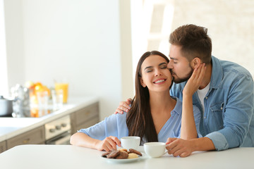 Wall Mural - Happy young couple in kitchen at home