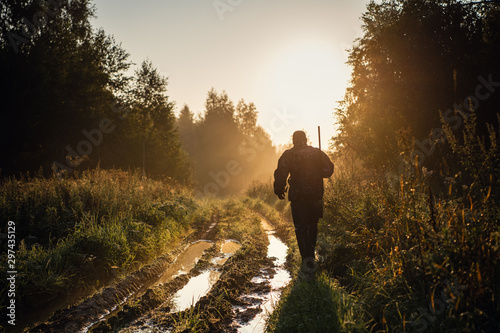 Vintage hunter walks the forest road Poster Mural XXL