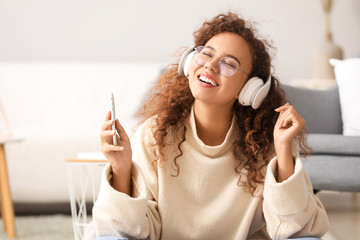 Poster - Beautiful African-American woman listening to music at home