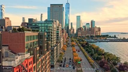 Fototapete - Drone footage with slow camera lift up along West Street in New York City on a sunny afternoon, before sunset
