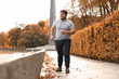 © New Africa - Young overweight man running in park. Fitness lifestyle
