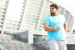 © New Africa - Young overweight man wearing earphones training outdoors