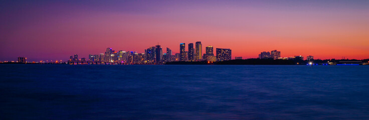 Wall Mural - panoramic view of sunset orange sky blue sea buildings city miami