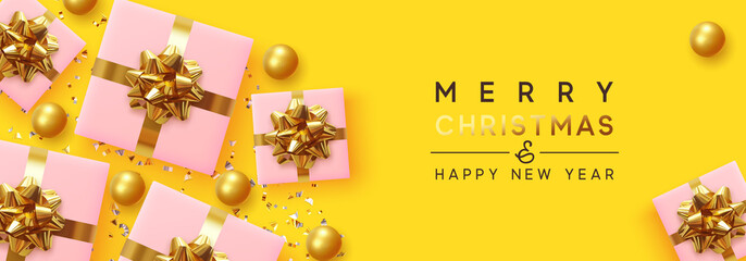 Wall Mural - Merry Christmas and Happy New Year. Yellow background with realistic festive gifts box. Xmas present. Pink gift surprise, flat top view. Golden Christmas baubles, balls, glitter gold confetti.