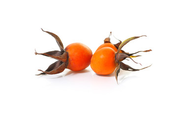 Wall Mural - orange rose hip on a white background, herbal tea ingredient