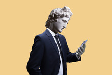 Modern Art Collage. Concept Portrait Of A  Businessman  Holding Mobile Smartphone Using App Texting Sms Message. Gypsum Head Of Of Apollo. Man In Suit.